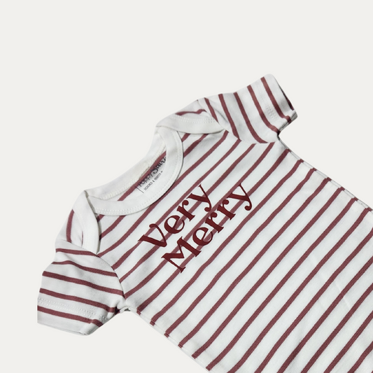 Close-up of the Very Merry print on the white and muted red striped baby onesie