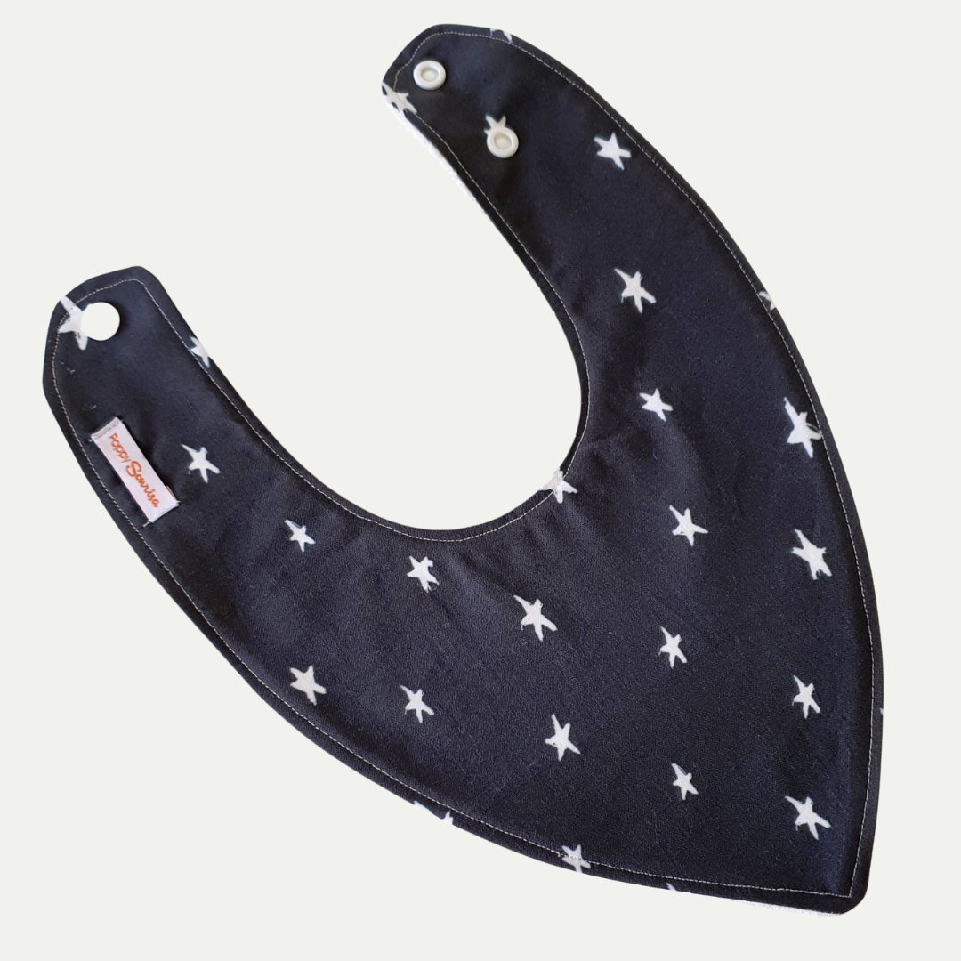 Baby dribble bib with small white five-pointed stars on a dark navy background.