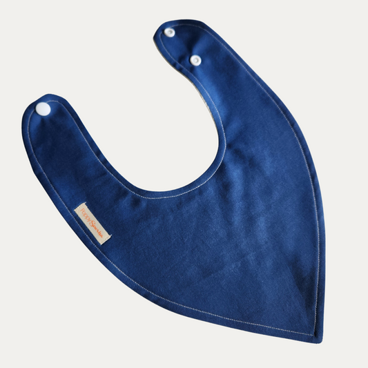 Plain navy blue baby dribble bib with white adjustable snaps and stitched edging.