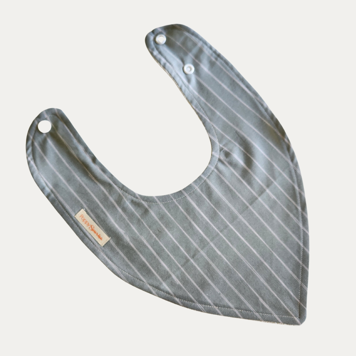Sage Freehand Stripes baby dribble bib featuring thin white freehand stripes on a muted sage background, with adjustable white snaps.